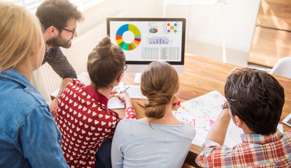 Workers looking at the monthly statistics